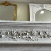 Belle et fine cheminée ancienne de style Louis XVI réalisée en marbre de carrare blanc datant de la fin du XIXème siècle bandeau sculpté d’un Rameau d’olivier et de roses .